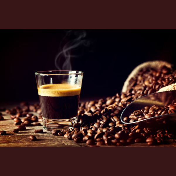 Granos de café esparcidos y taza de café